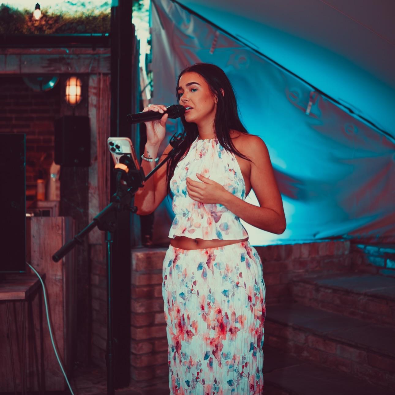 Annabelle Pamela singing at an evening party
